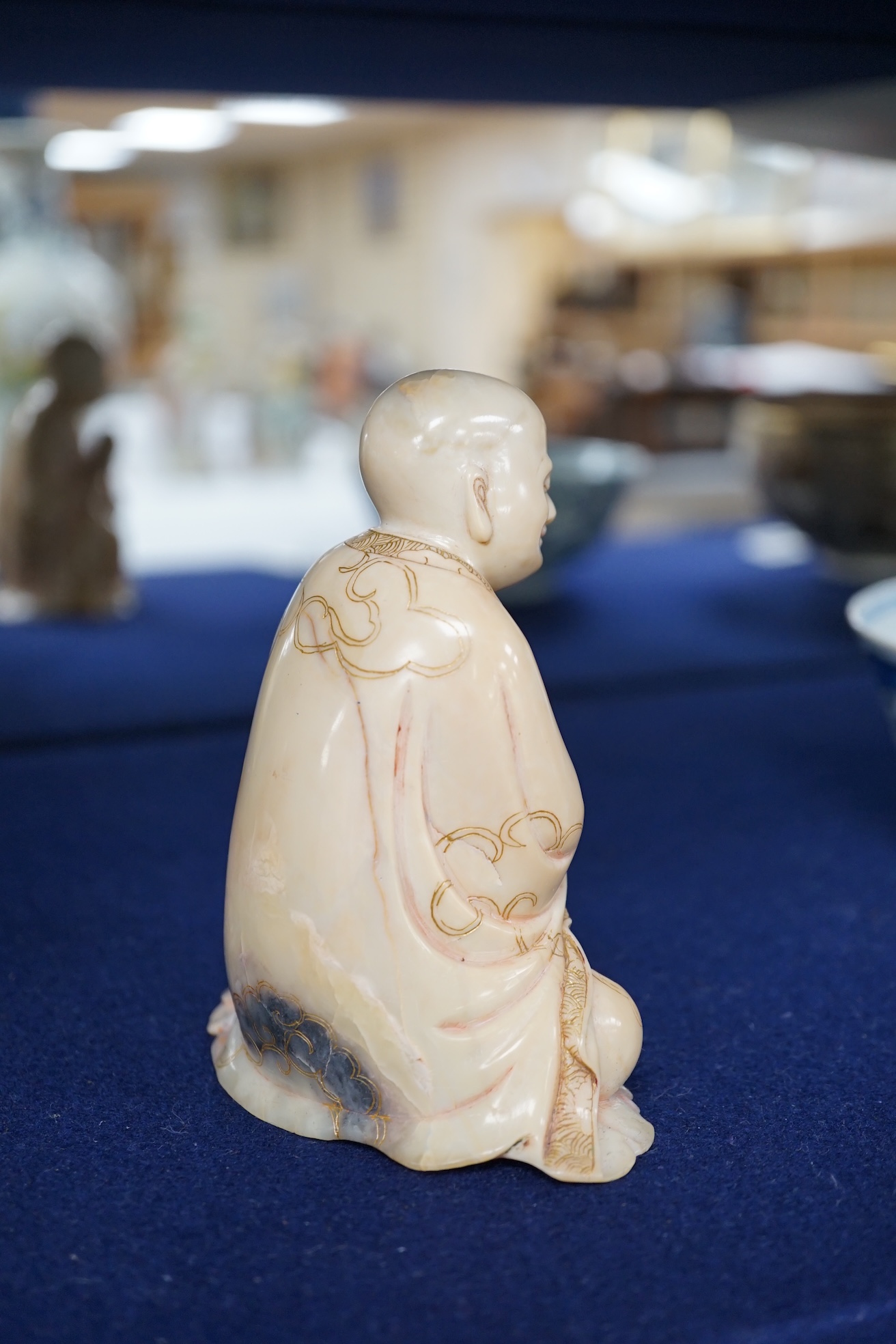 An 18th century carved soapstone figure of a seated luohan, 12cm high. Condition - good